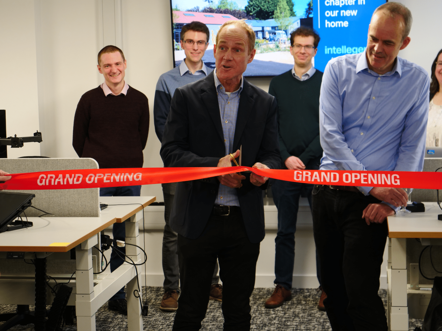 Intellegens board member Graham Snudden cuts the ribbon at the office opening together with CEO Ben Pellegrini